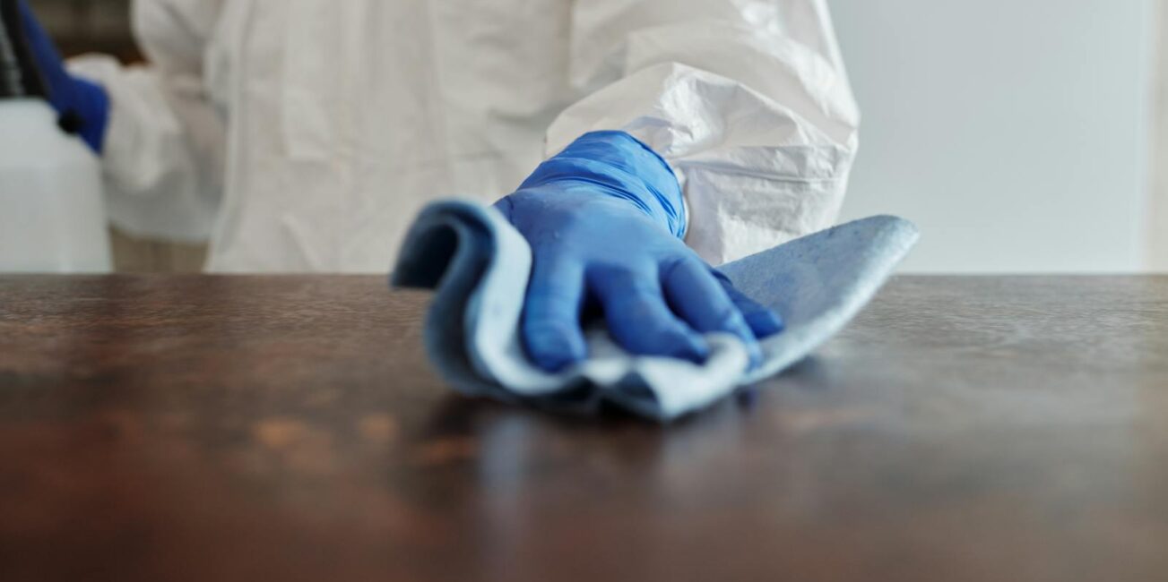 Close-Up Photo Of Person Cleaning The Table