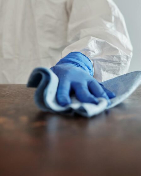 Close-Up Photo Of Person Cleaning The Table