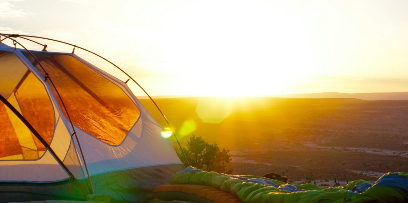 camping tent on cliff during golden hour